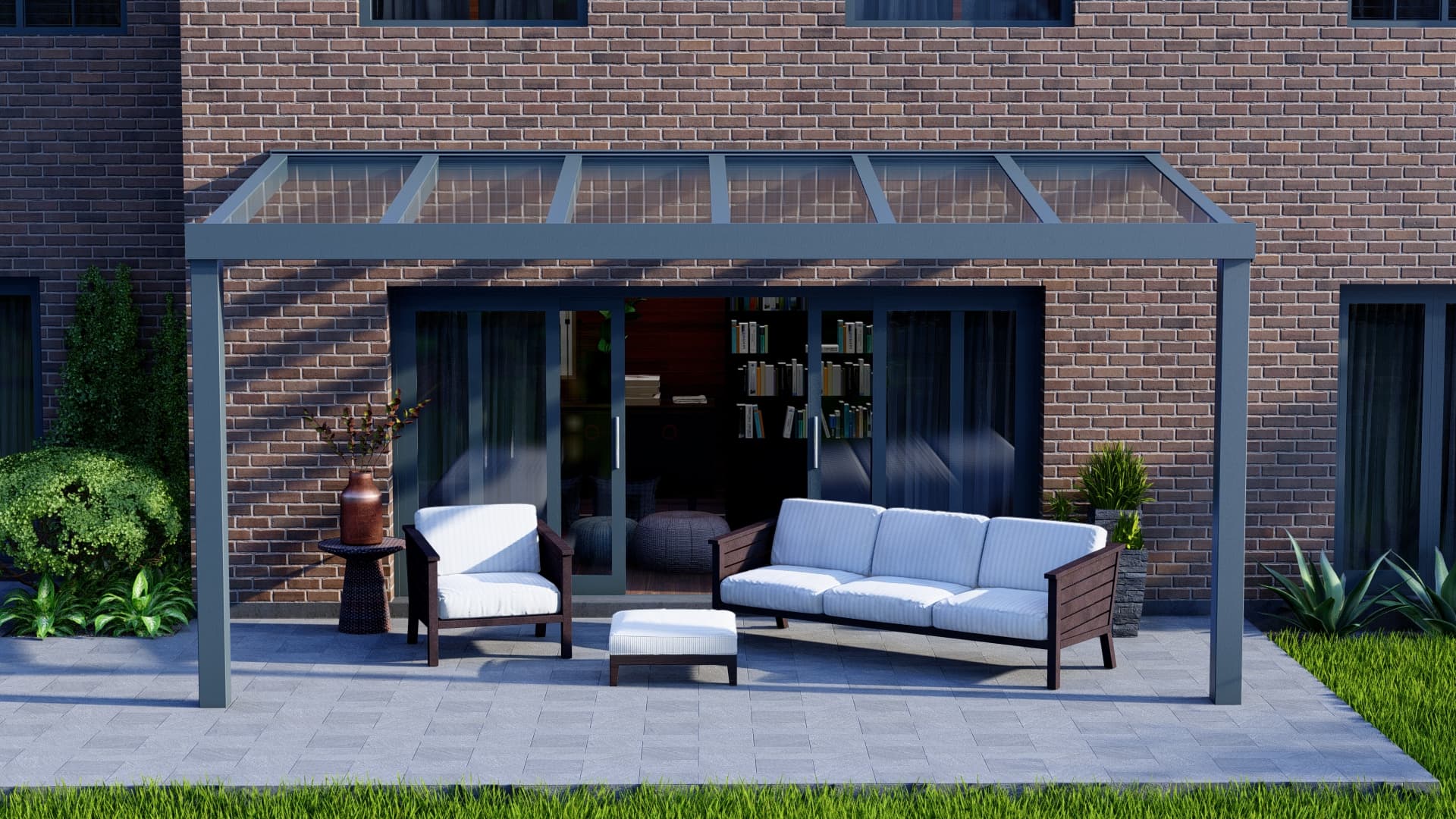 Pergola en aluminium anthracite à toiture vitrée contre une façade en brique, abritant un salon de jardin sur une terrasse en dalles